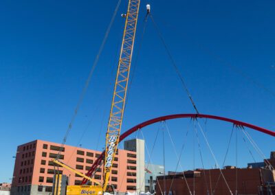 Crawler crane hoisting pedestrian bridge in Emeryville