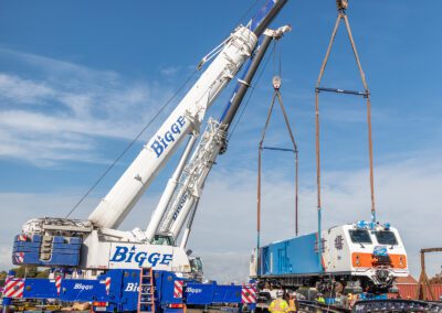 Cranes hoisting maintenance equipment for BART