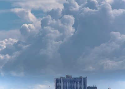 billowing clouds dwarf the skyline of downtown Oakland