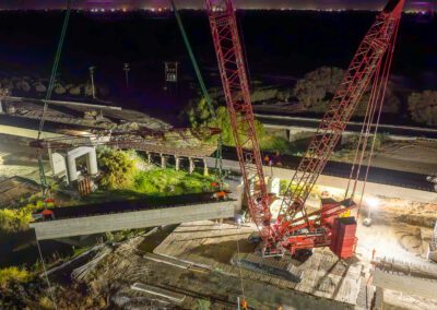 Crawler crane hoisting girders for California High Speed Raid project in Corcoran, CA
