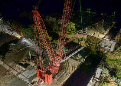 Crawler crane hoisting girders for California High Speed Raid project in Corcoran, CA