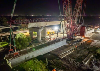 Crawler crane hoisting girders for California High Speed Raid project in Corcoran, CA