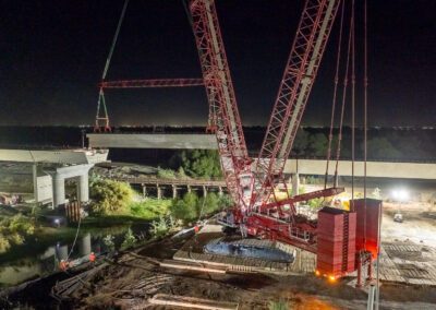 Crawler crane hoisting girders for California High Speed Raid project in Corcoran, CA