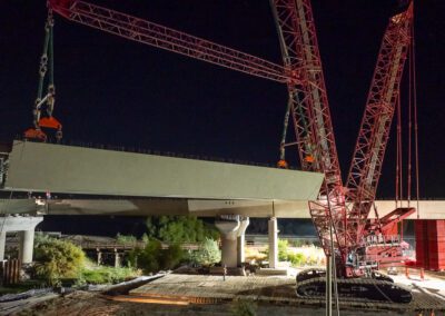 Crawler crane hoisting girders for California High Speed Raid project in Corcoran, CA