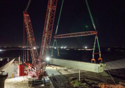 Crawler crane hoisting girders for California High Speed Raid project in Corcoran, CA