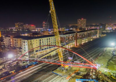 Crawler crane hoisting pedestrian bridge in Emeryville