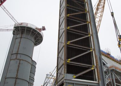 Cranes work at a power plant in Huntington Beach, California
