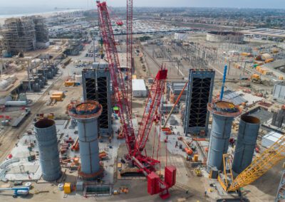 Cranes work at a power plant in Huntington Beach, California