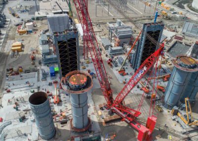 Cranes work at a power plant in Huntington Beach, California